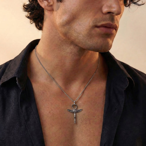 Young man in open-neck shirt wearing Thomas Sabo cross of life ankh scarab pendant.