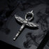 Thomas Sabo cross of life ankh scarab pendant laying on a dark mirrored surface surrounded by mystical black smoke.
