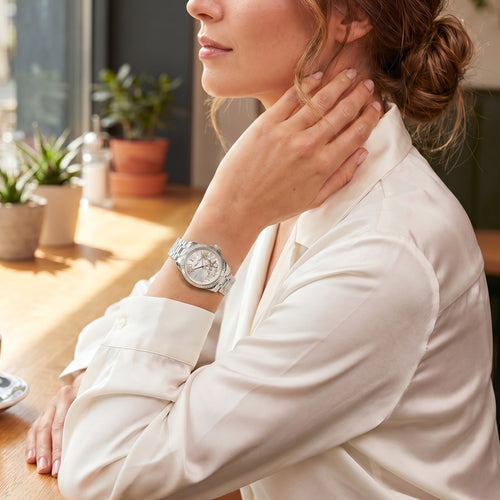 Woman wearing a Thomas Sabo Ladies Flowers gemstone dial silver watch.