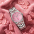 Thomas Sabo Haribo Goldbear watch on pink fabric surrounded by pink gummy bears.