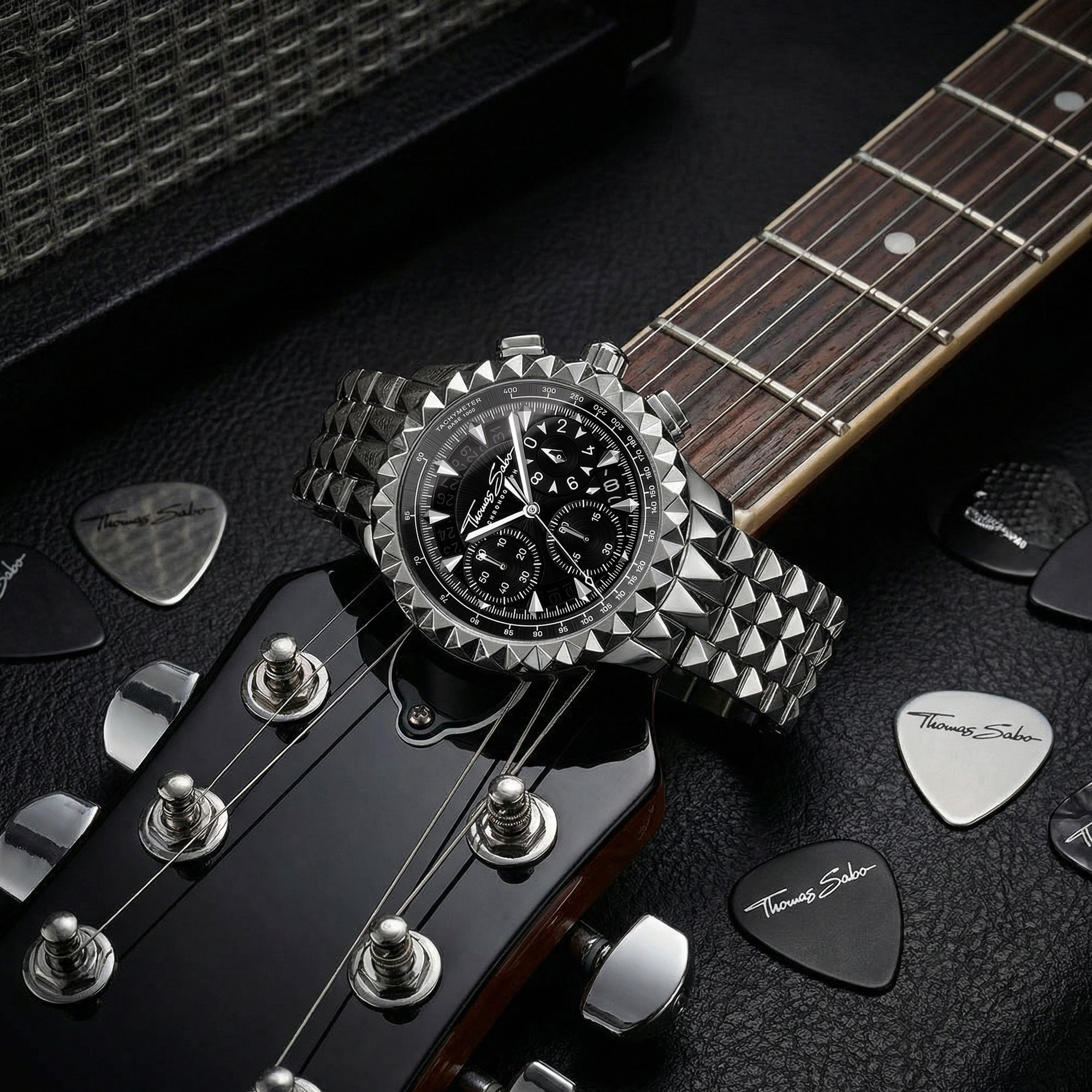 Thomas Sabo Rebel At Heart silver pyramid men's watch with an electric guitar surrounded by guitar picks.