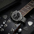 Thomas Sabo Rebel At Heart silver pyramid men's watch with an electric guitar surrounded by guitar picks.