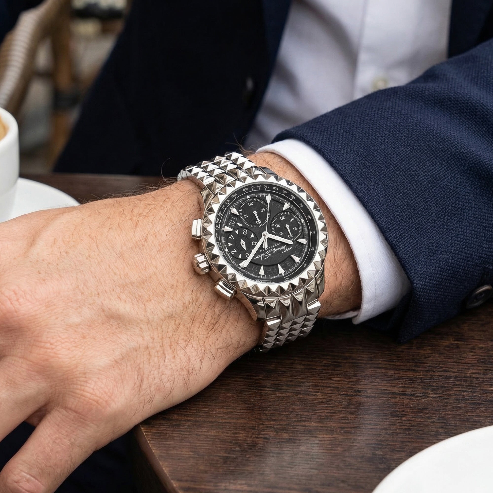 Man in suit wearing Thomas Sabo Rebel At Heart silver pyramid men's watch on his wrist.