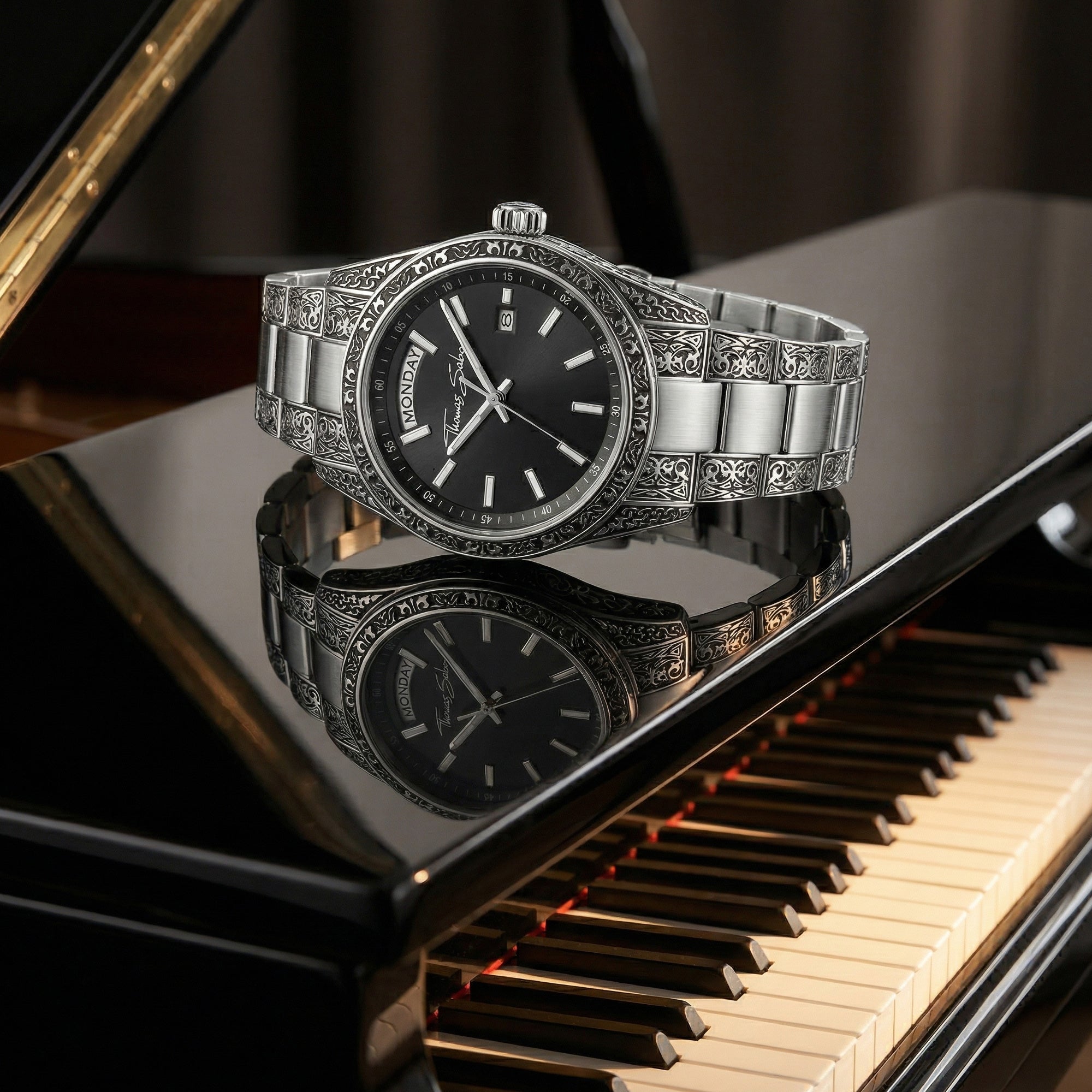 Thomas Sabo Rebel At Heart Revive 36mm black dial watch laying on the lid of a mirror surface gloss black piano.