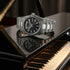 Thomas Sabo Rebel At Heart Revive 36mm black dial watch laying on the lid of a mirror surface gloss black piano.