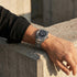 Man wresting his hand on a concrete block wearing a Thomas Sabo Rebel At Heart Revive 40mm black dial watch.