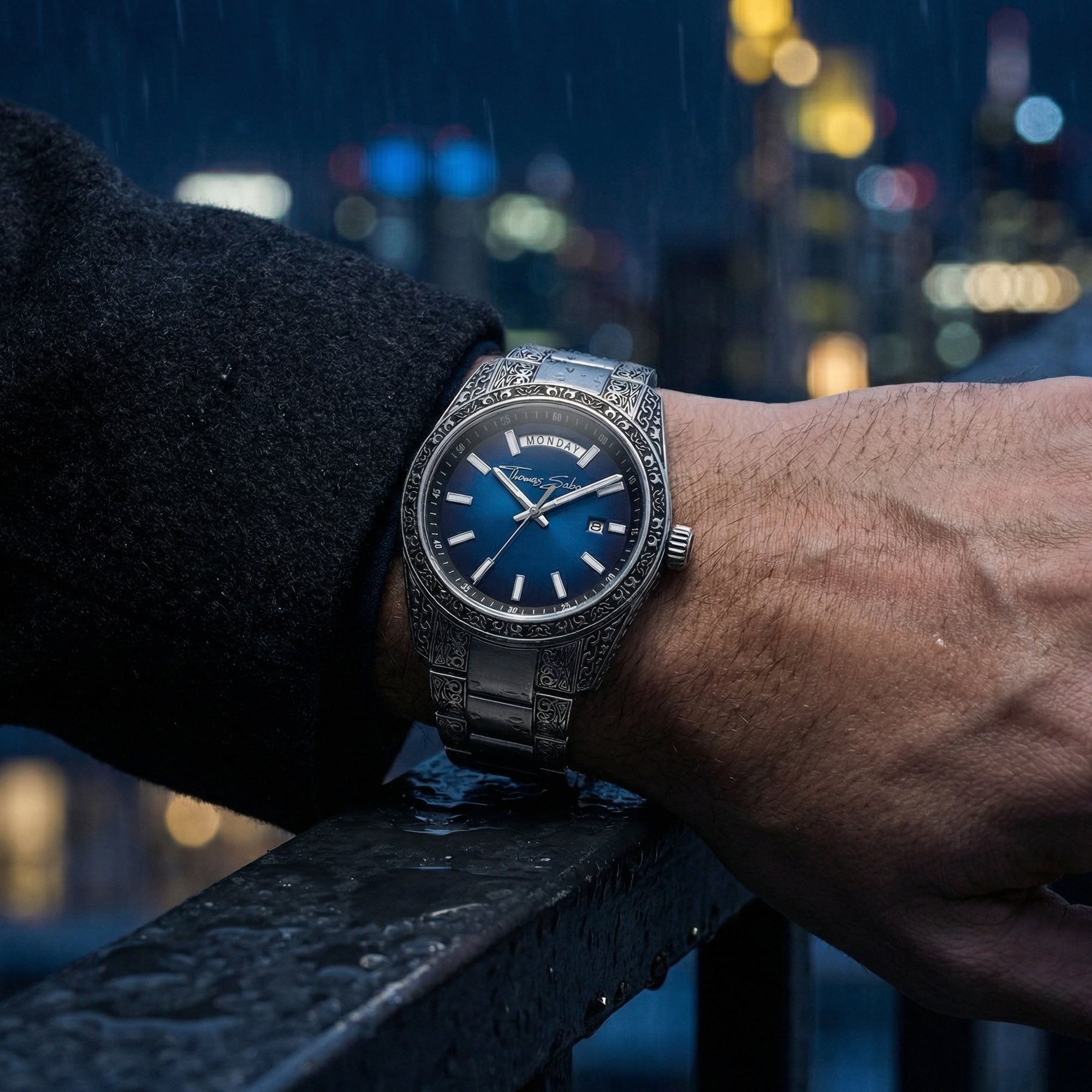 Man wearing a Thomas Sabo Rebel At Heart Revive 40mm blue dial watch in the rain on the rooftop of a building.