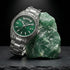 Thomas Sabo Rebel At Heart Revive 36mm green dial watch laying against a raw piece of jade.