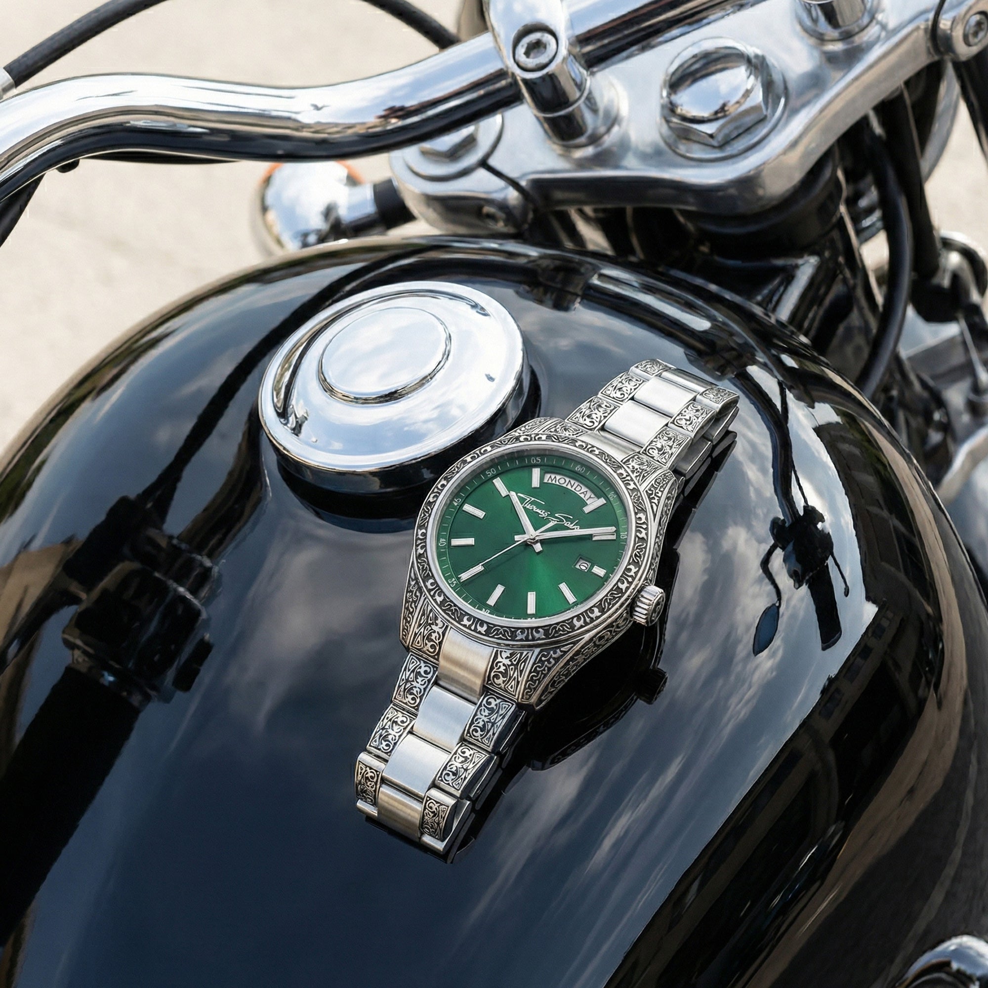Thomas Sabo Rebel At Heart Revive 36mm green dial watch resting on the black fuel tank of a motorcycle.