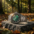 Thomas Sabo Rebel At Heart Revive 40mm green dial watch laying on a piece of black granite in a forest canopy with dappled light breaking through the treetops.