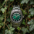 Thomas Sabo Rebel At Heart Revive 40mm green dial watch laying in a clump of dark green ivy.