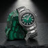 Thomas Sabo Rebel At Heart Revive 40mm green dial watch leaning against a rough piece of malachite sitting on a black slate surface.