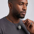 Man wearing Thomas Sabo Rebel Wolf Head sterling silver pendant on a silver chain.