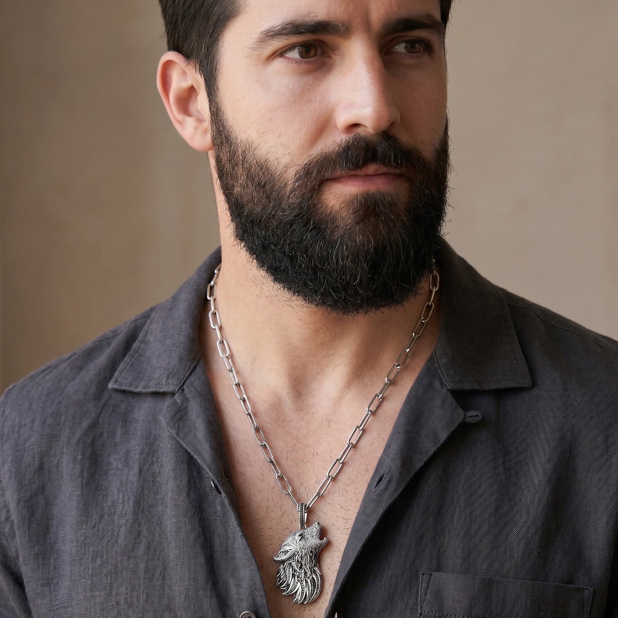 Man wearing a Thomas Sabo Rebel Wolf sterling silver pendant on a wide chain.