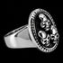 Side view of a three skulls stainless steel men's signet ring.
