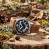 Timberland Lemington silver black dial tan leather watch in a bush setting.