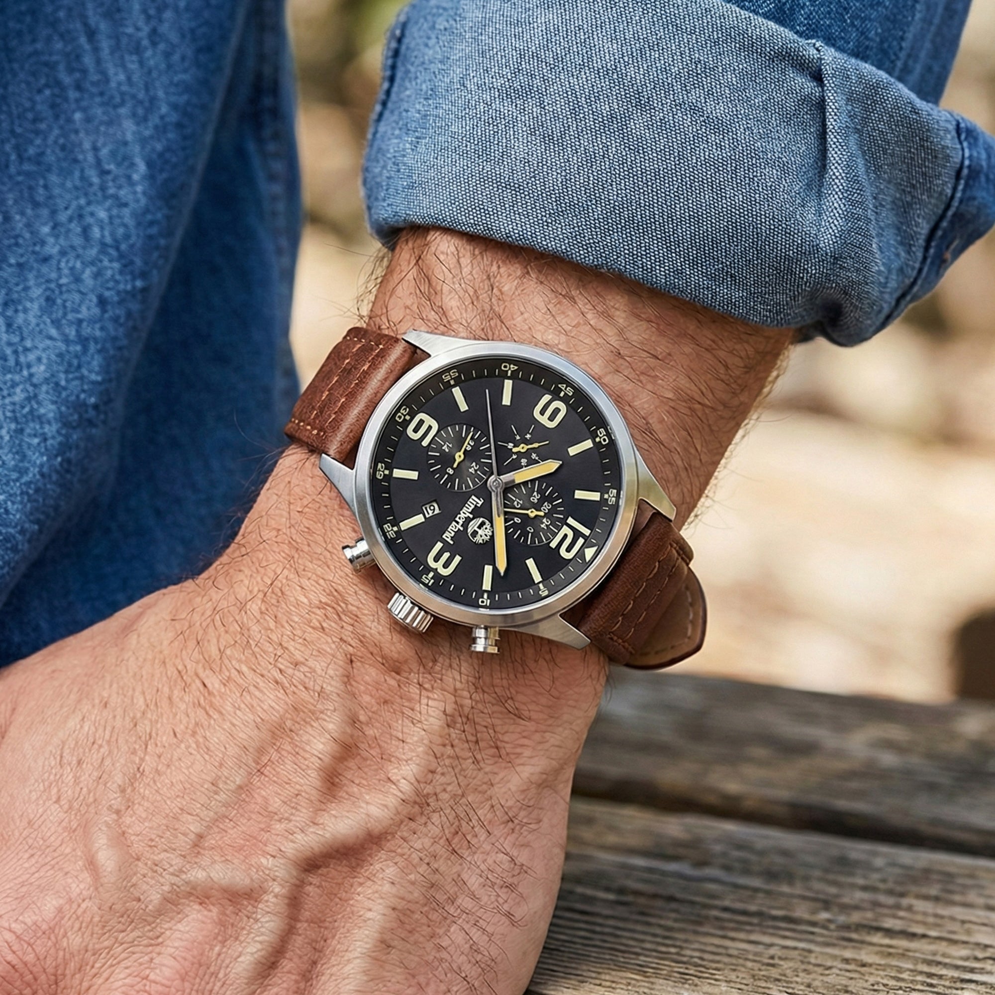 Man wearing Timberland Rutherford black dial brown leather watch.
