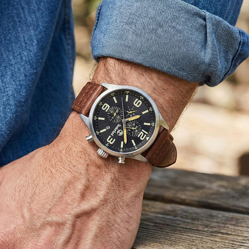 Man wearing Timberland Rutherford black dial brown leather watch.