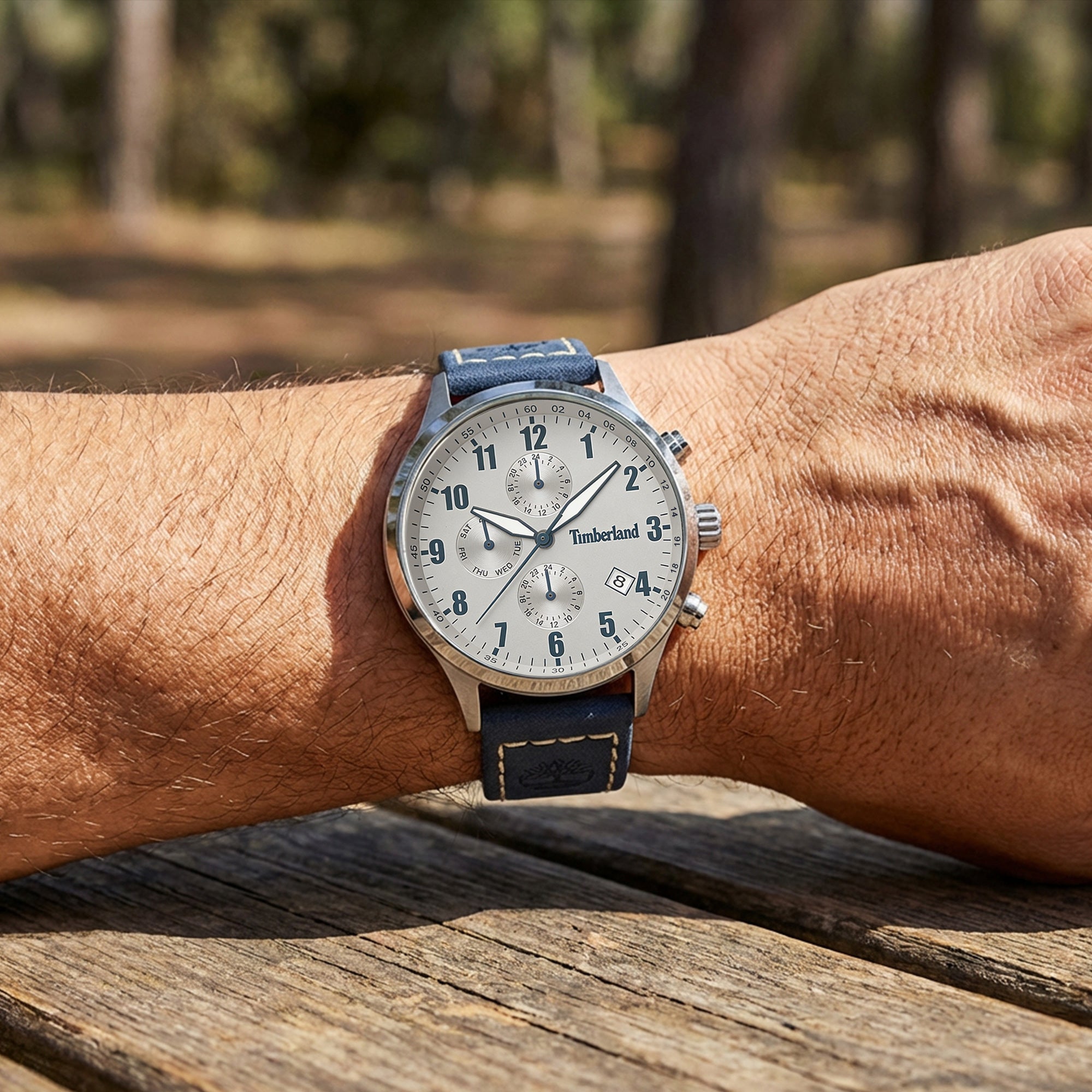 Man wearing Timberland men's Stoughton silver dial blue leather watch.