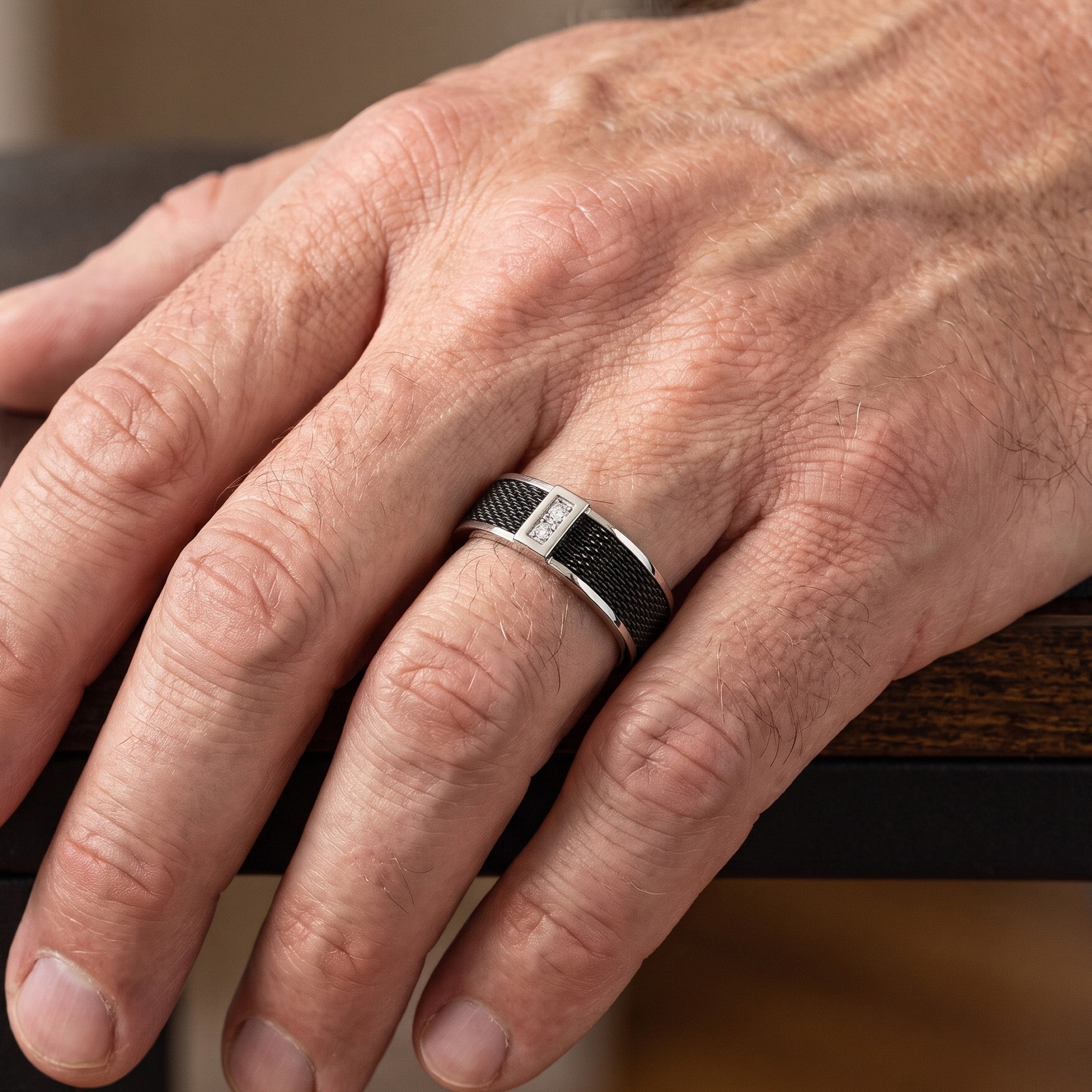 Man wearing a titanium black mesh twin CZ men's ring on his hand,