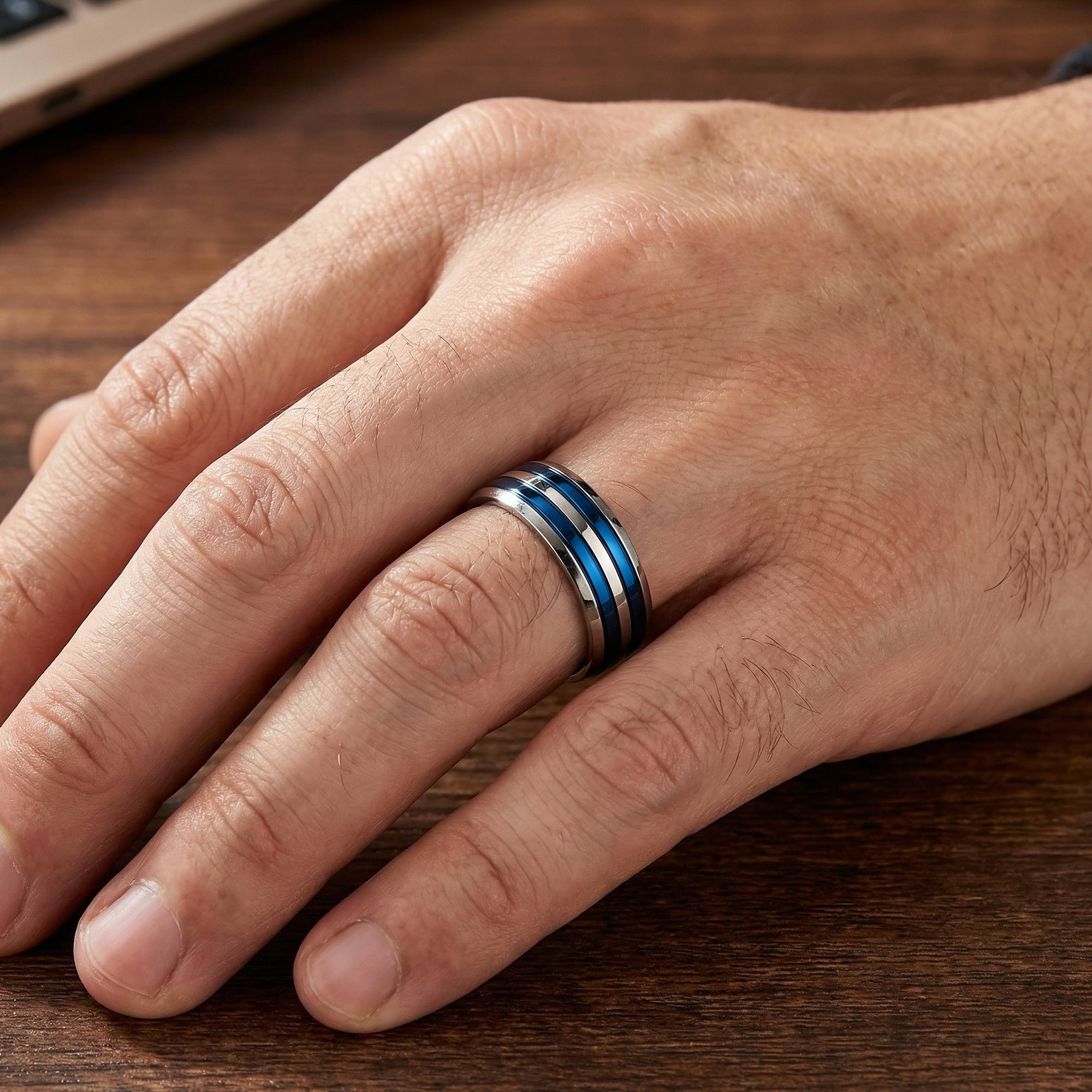 Man wearing titanium men's blue multi band ring.
