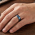 Man wearing titanium men's blue multi band ring.