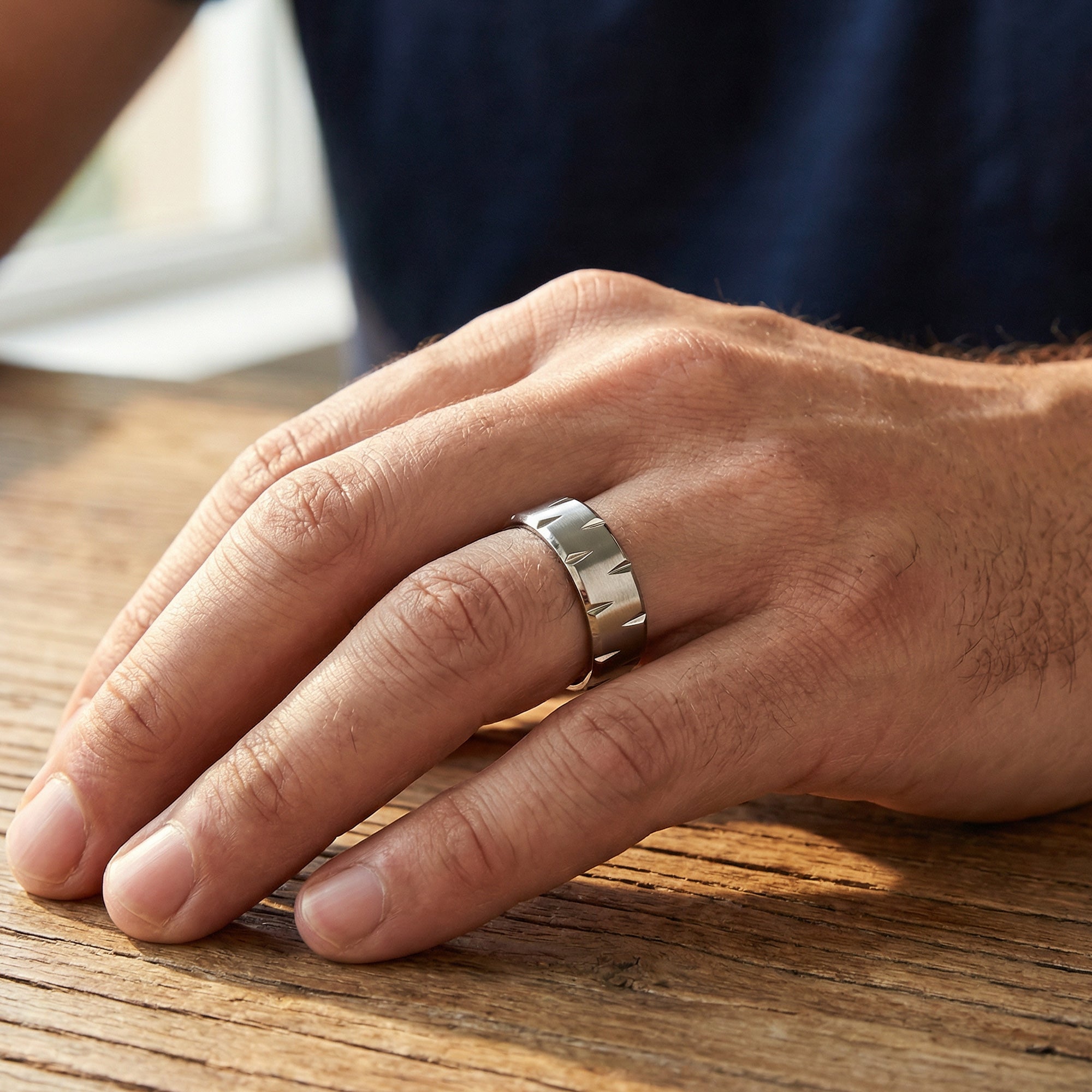 Man wearing titanium matte finish notched edge ring.