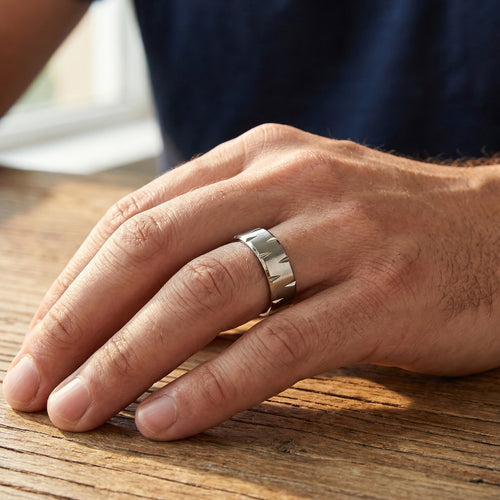Man wearing titanium matte finish notched edge ring.