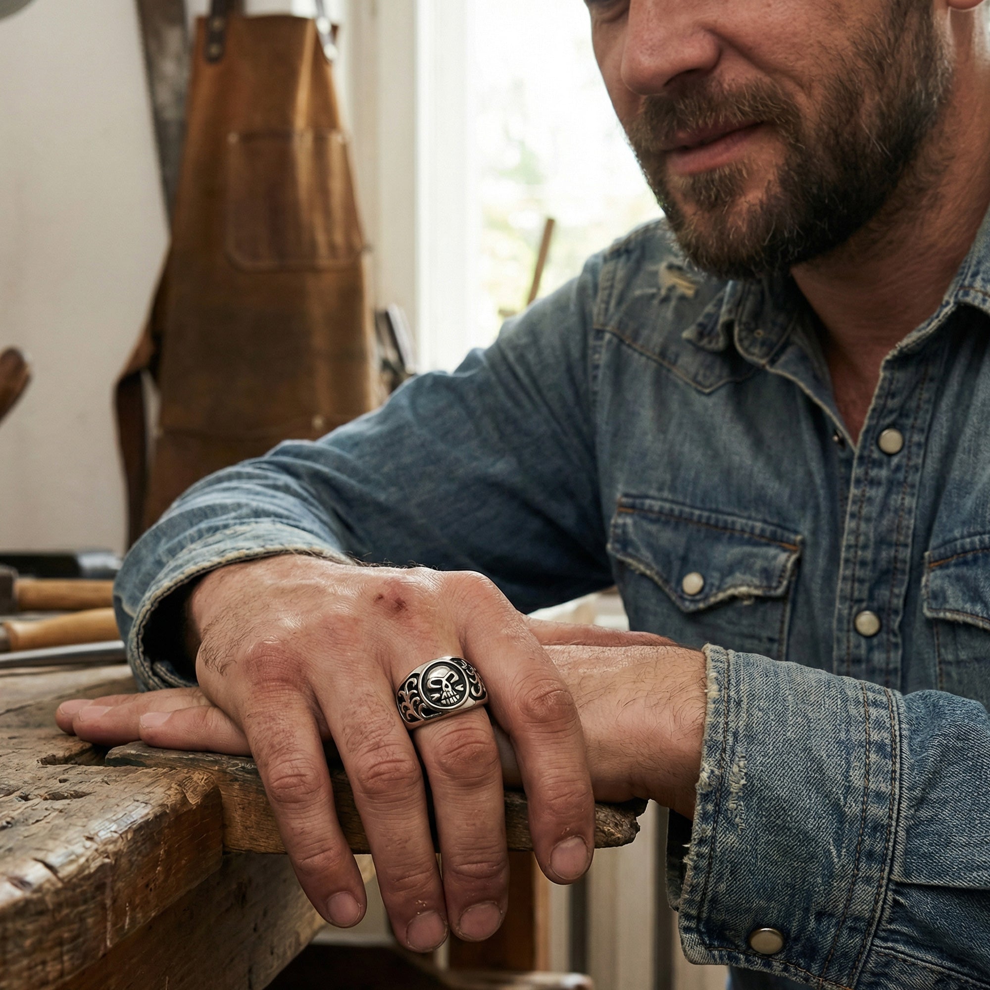 Handsome man wearing men's tribal skull stainless steel ring.