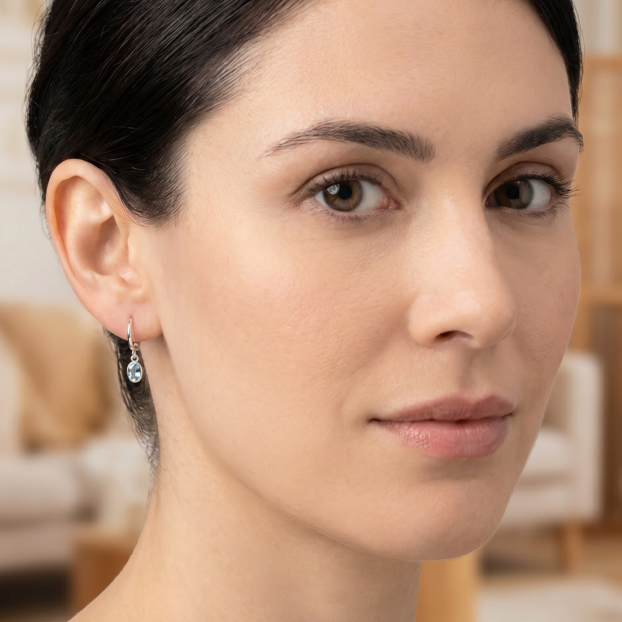 Woman wearing Engelsrufer turquoise blue CZ hoop dangle earrings.
