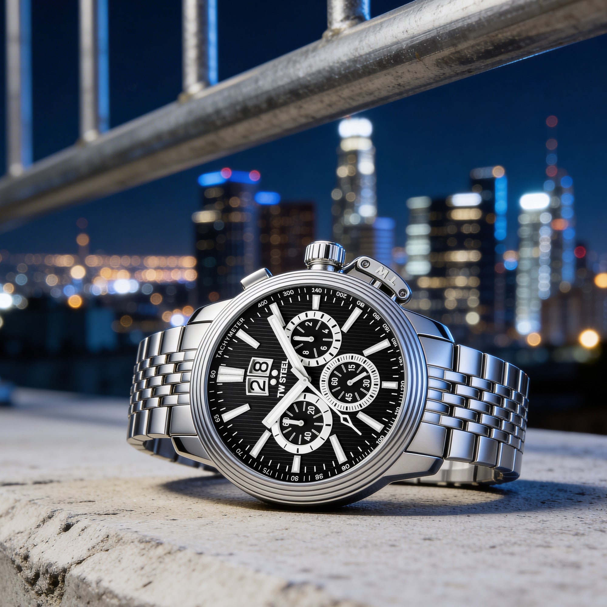 TW Steel CEO Adesso CE7019 black dial chronograph watch on a concrete ledge with a big city scape in the background.
