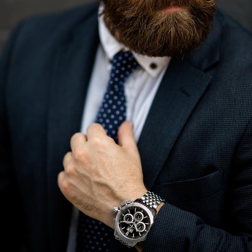 Man in a business suit wearing TW Steel CEO Adesso CE7019 black dial chronograph watch.