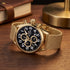 TW Steel VS88 Volante gold black dial numbers chronograph watch on an old wooden desk.