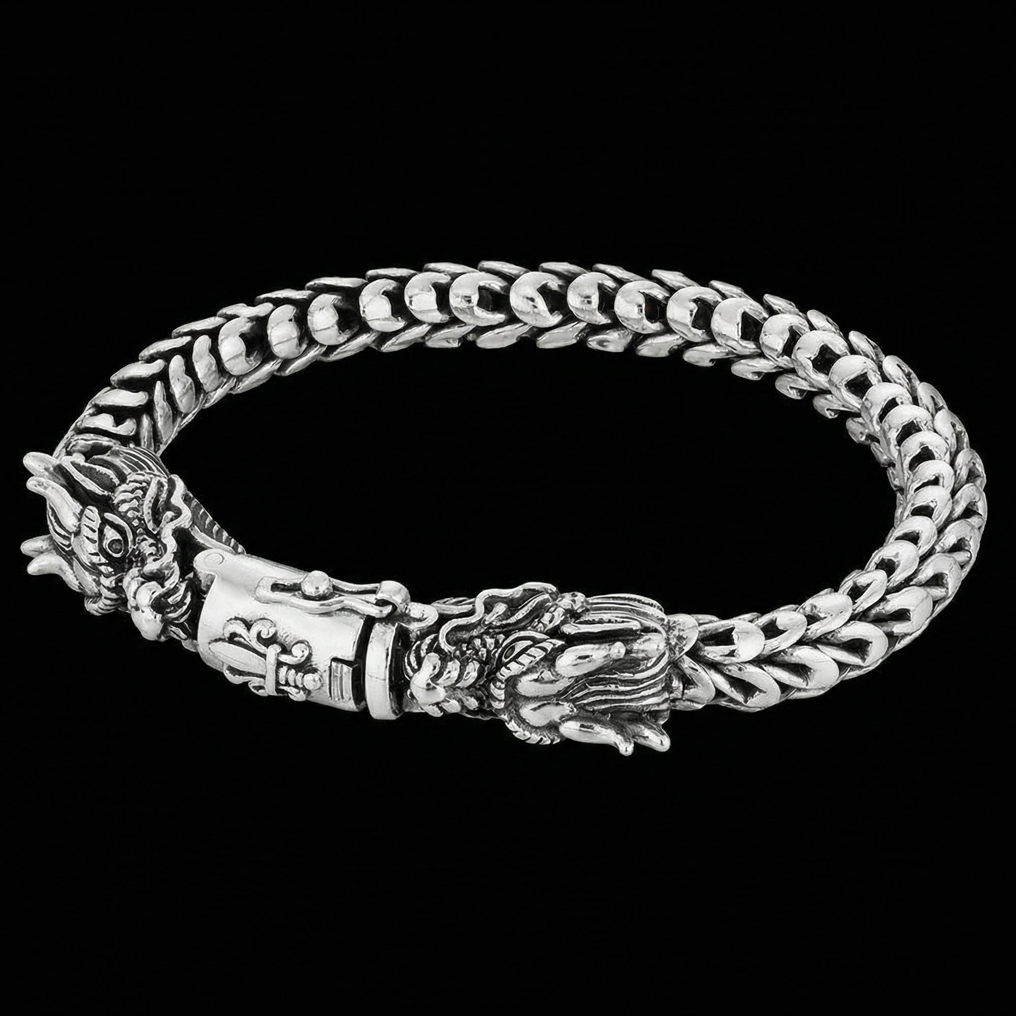Close-up of twin dragon heads sterling silver bracelet.