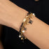 Close-up of a woman's wrist wearing an Engelsrufer wind rose gold and black boho pearl bracelet.