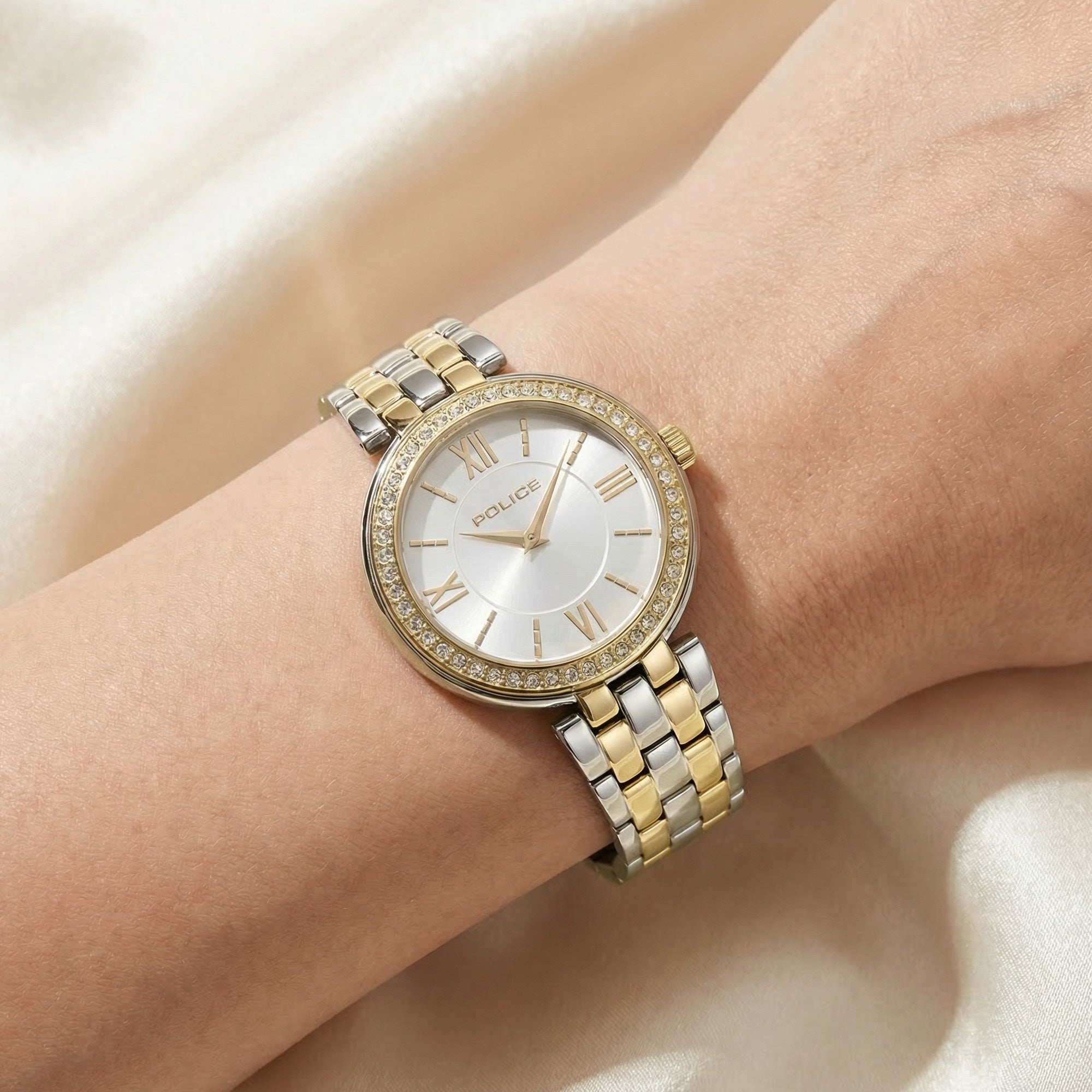 Woman wearing Police ladies Magnificence gold two tone watch.