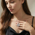 Woman in a black dress wearing an Engelsrufer sterling silver yin yang om balance pendant.