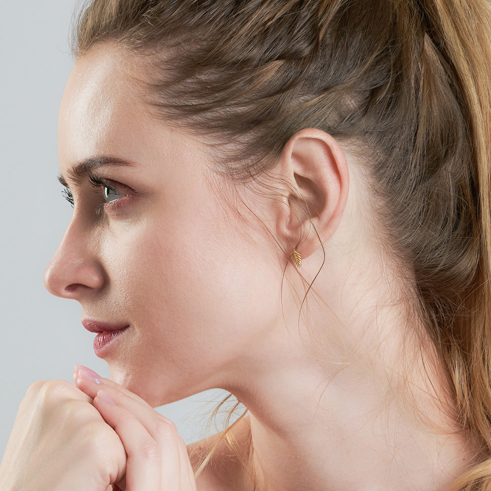 ANIA HAIE TROPIC THUNDER GOLD PALM STUD EARRINGS - MODEL VIEW