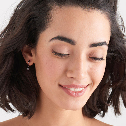 ANIA HAIE GLOW GETTER SILVER GLOW HUGGIE HOOP EARRINGS - MODEL VIEW