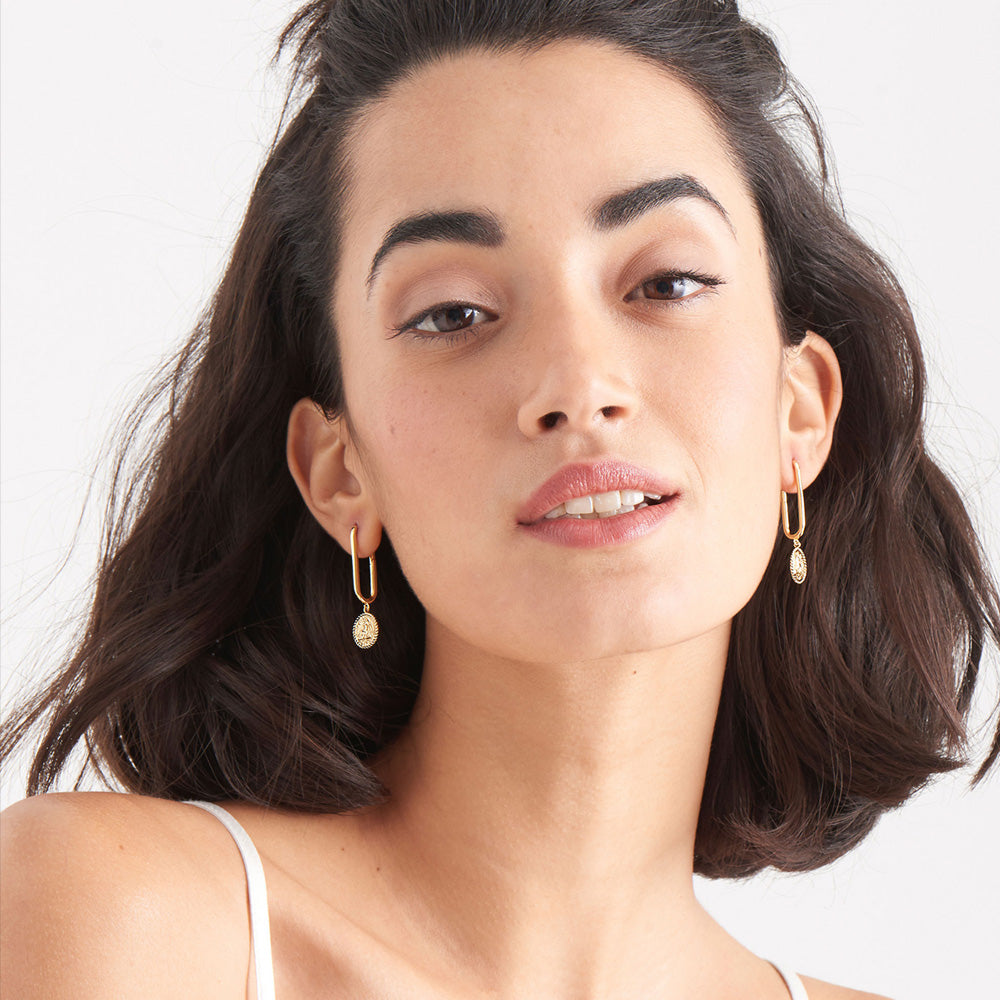 ANIA HAIE GOLD DIGGER WINGED GODDESS DROP OVAL HOOP EARRINGS - MODEL VIEW
