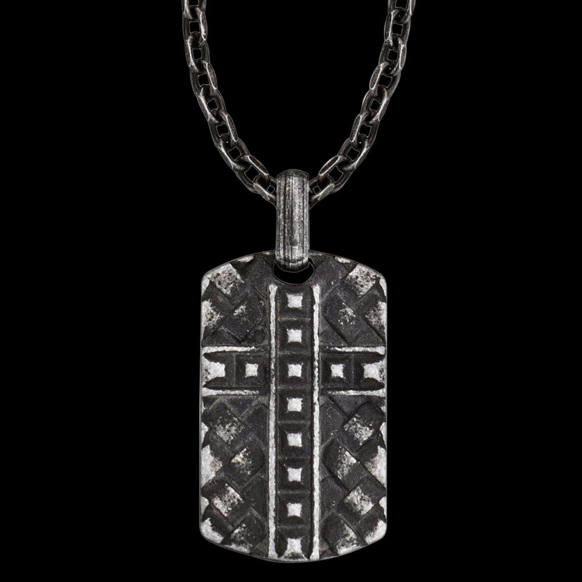 Close-up of black steel men's cross dog tag necklace.