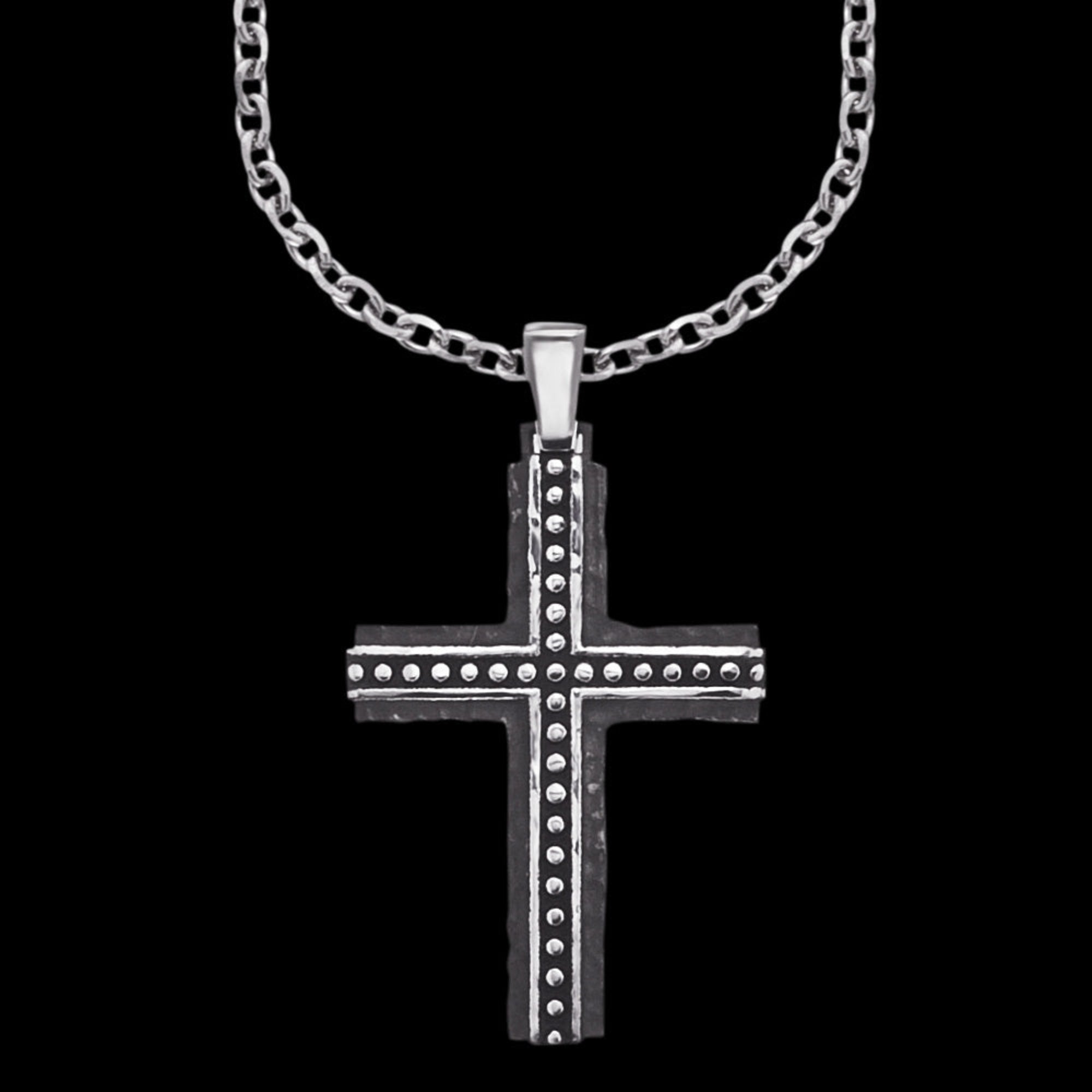 Close up of a rough edge black steel cross men's necklace.