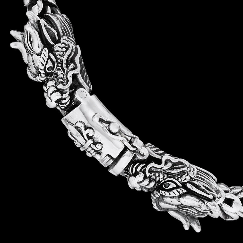 Twin dragon heads sterling silver bracelet clasp close-up.